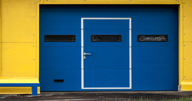 Garage door with small door